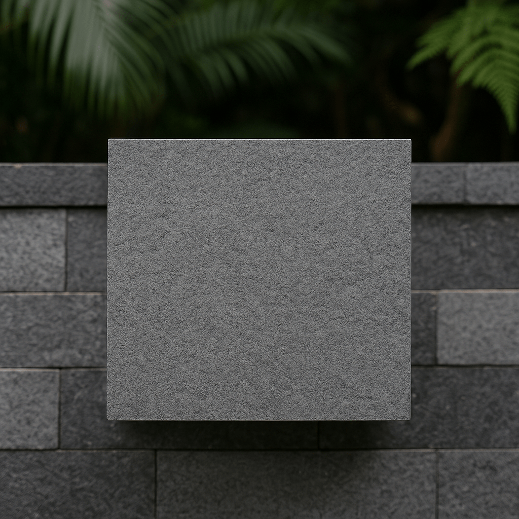 Close-up view of andesite stone tile sample with stacked background wall